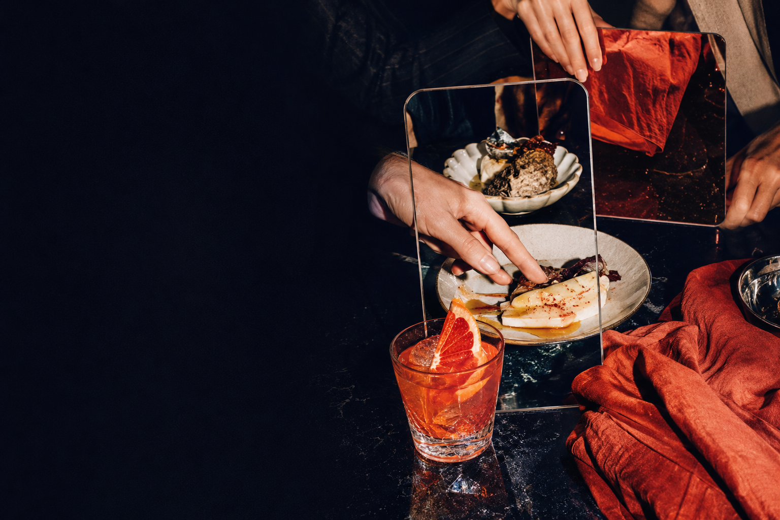 A vivid editorial hospitality scene with hands, food and candid human energy